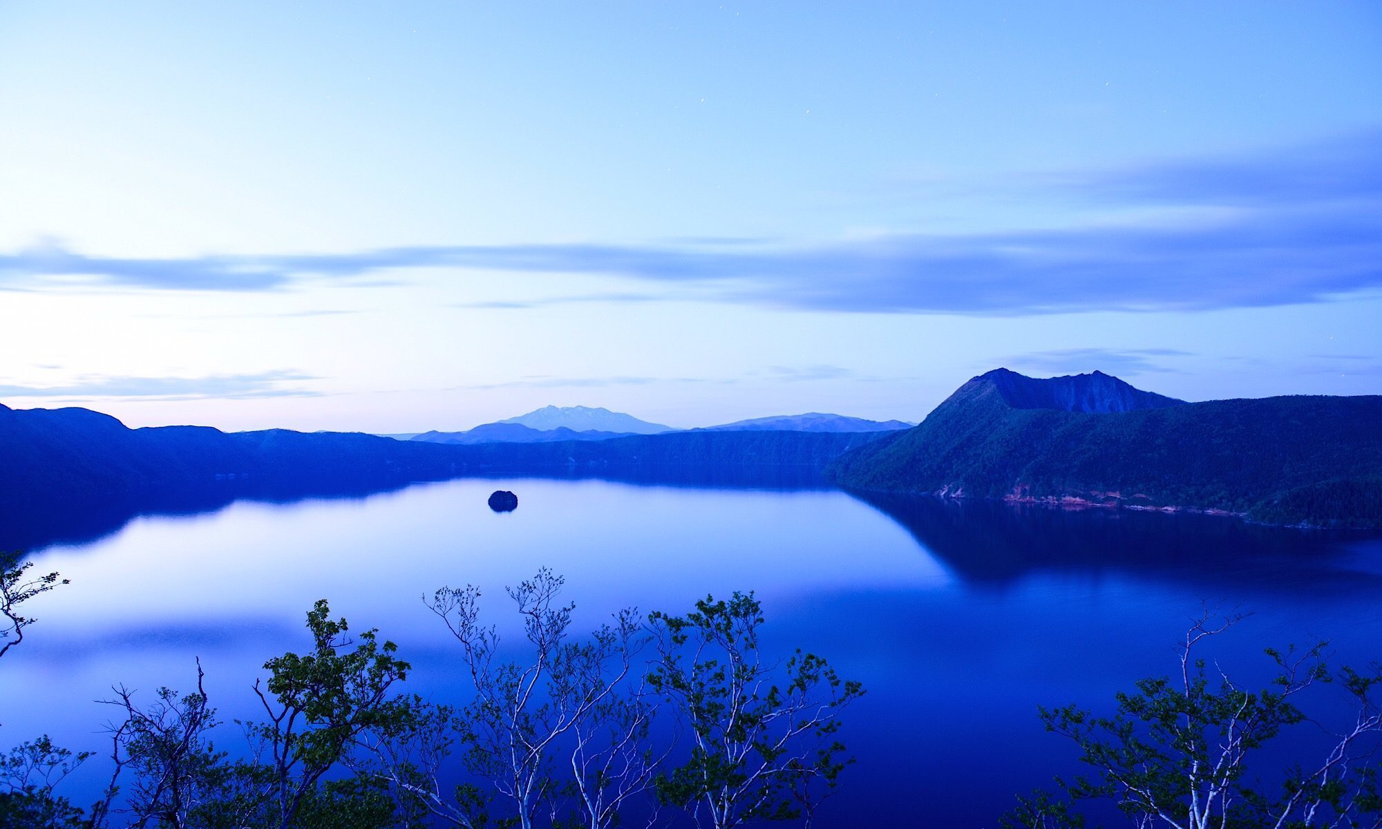 ブランドイメージコンセプトとなる北海道の摩周湖に浮かぶカムイッシュ島。ブルーに染まる美しい夕景画像。